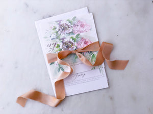 handmade and hand dyed narrow silk ribbon by the yard wrapped around a paper wedding invitation