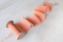 Load image into Gallery viewer, handmade silk chiffon ribbon in Coral Pink with a hand torn frayed edge. On a wooden spool
