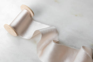 Pale blush pure silk ribbon, handmade and hand dyed in Oregon. Sold by the yard on a wooden spool