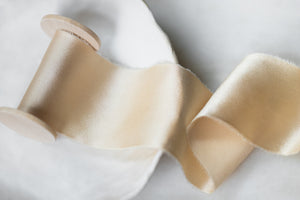 Handmade and hand dyed ivory silk ribbon with all natural dyes. 100% silk ribbon with a hand torn edge, sent on a wooden spool.